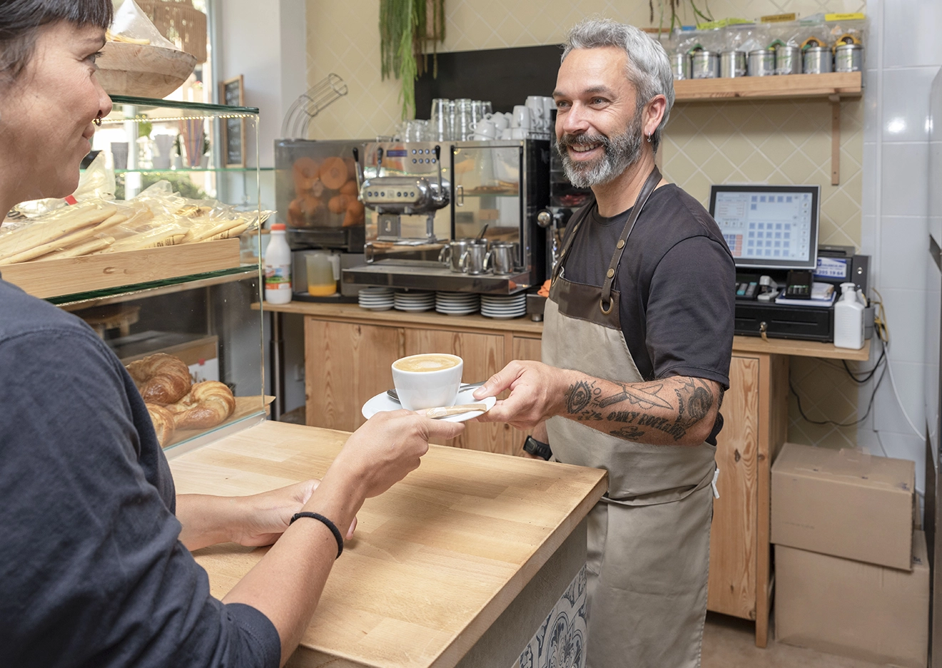 Cafe owner serving a customer